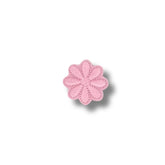 Flor rosada pastel de ocho pétalos con contorno fino.