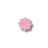 Flor rosada pastel de ocho pétalos con contorno fino.